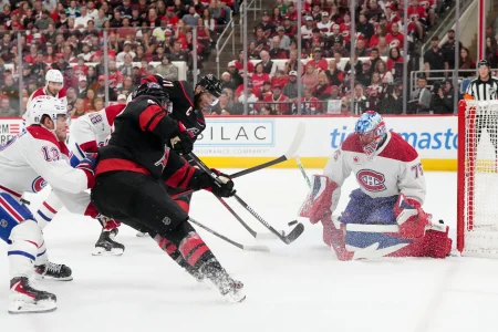 May 21, 2026; Raleigh, North Carolina, USA; Montreal Canadiens goaltender Jakub Dobes (75) defends the net against a shot by Carolina Hurricanes left wing Jordan Martinook (48) during the first period in game one of the Eastern Conferene Final of the 2026 Stanley Cup Playoffs at Lenovo Center.
