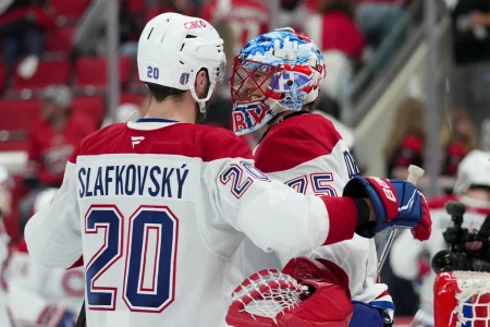 May 21, 2026; Raleigh, North Carolina, USA; Montreal Canadiens left wing Juraj Slafkovsky (20) congratulates goaltender Jakub Dobes (75) after a win against the Carolina Hurricanes of game one of the Eastern Conferene Final of the 2026 Stanley Cup Playoffs at Lenovo Center.
