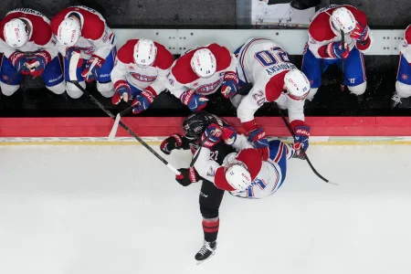 May 21, 2026; Raleigh, North Carolina, USA; Montreal Canadiens center Jake Evans (71) checks Carolina Hurricanes center Logan Stankoven (22) into the boards during the third period in game one of the Eastern Conferene Final of the 2026 Stanley Cup Playoffs at Lenovo Center.
