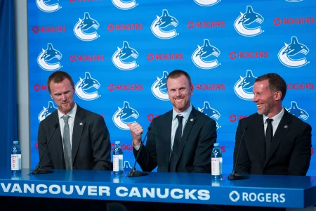 May 14, 2026; Vancouver, BC, Canada; Henrik Sedin and Daniel Sedin and Ryan Johnson share smiles during a press conference where the Vancouver Canucks name new senior management staff. Henrik Sedin and his twin brother Daniel Sedin have been appointed as co-presidents of hockey operations and Ryan Johnson is now the new general manager of the club at Rogers Arena.