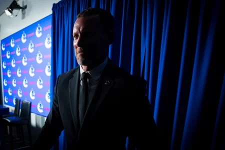 May 14, 2026; Vancouver, BC, Canada; Ryan Johnson shakes hands with a member of the media during a press conference where the Vancouver Canucks name new senior management staff. Henrik Sedin and his twin brother Daniel Sedin have been appointed as co-presidents of hockey operations and Ryan Johnson is now the new general manager of the club at Rogers Arena.