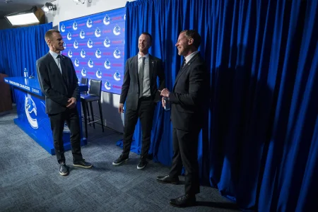 May 14, 2026; Vancouver, BC, Canada; The Vancouver Canucks promoted Daniel Sedin (left) and his twin brother Henrik Sedin (center) to co-presidents and Ryan Johnson (right) was named the Canucks new general manger during a press conference at Rogers Arena.
