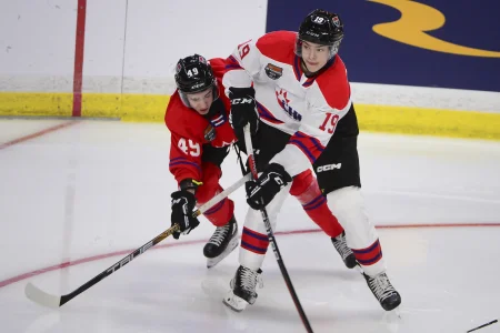 Jan 25, 2023; Langley, BC, CANADA; CHL Top Prospects team white forward Ethan Miedema (19) controls the puck against against CHL Top Prospects team red defenseman Jordan Tourigny (49) during the third period in the 2023 CHL Top Prospects ice hockey game at Langley Events Centre. Mandatory Credit: Anne-Marie Sorvin-Imagn Images