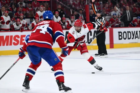 May 27, 2026; Montreal, Quebec, CAN; Carolina Hurricanes defenseman Shayne Gostisbehere (4) shoots the puck against the Montreal Canadiens during the second period in game four of the Eastern Conference Final of the 2026 Stanley Cup Playoffs at Bell Centre.