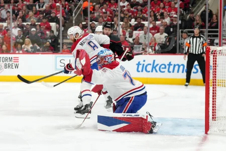 May 29, 2026; Raleigh, North Carolina, USA; Montreal Canadiens goaltender Jakub Dobes (75) and defenseman Mike Matheson (8) defend against Carolina Hurricanes left wing Taylor Hall (71) in game five of the Eastern Conference Final of the 2026 Stanley Cup Playoffs during the first period at Lenovo Center.