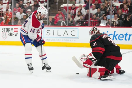 May 23, 2026; Raleigh, North Carolina, USA; Carolina Hurricanes goaltender Frederik Andersen (31) saves a shot on goal from Montréal Canadiens center Nick Suzuki (14) during the second period in game two of the Eastern Conferene Final of the 2026 Stanley Cup Playoffs at Lenovo Center.