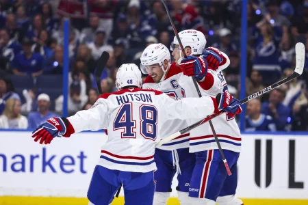 Apr 19, 2026; Tampa, Florida, USA; Montreal Canadiens forward Juraj Slafkovsky (20) reacts to scoring a goal with defenseman Lane Hutson (48) and forward Nick Suzuki (14) against the Tampa Bay Lightning during the second period in game one of the first round of the 2026 Stanley Cup Playoffs at Benchmark International Arena.