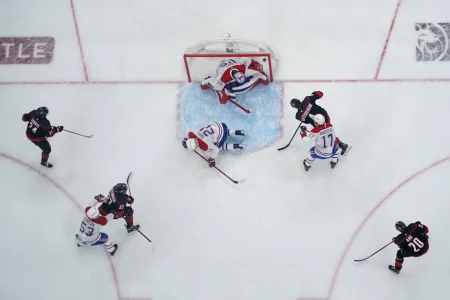 May 29, 2026; Raleigh, North Carolina, USA; Carolina Hurricanes defenseman Shayne Gostisbehere (4) scores a power play goal against Montreal Canadiens goaltender Jakub Dobes (75) in game five of the Eastern Conference Final of the 2026 Stanley Cup Playoffs during the second period at Lenovo Center.