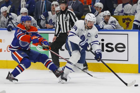 Feb 3, 2026; Edmonton, Alberta, CAN; Edmonton Oilers forward Connor McDavid (97) tries to knock the puck away from Toronto Maple Leafs forward Auston Matthews (34) during the first period at Rogers Place.