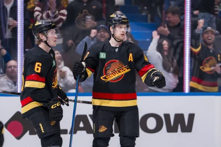 Mar 7, 2025; Vancouver, British Columbia, CAN; Vancouver Canucks forward Brock Boeser (6) celebrates forward Elias Pettersson (40) goal against the Minnesota Wild during the first period at Rogers Arena.