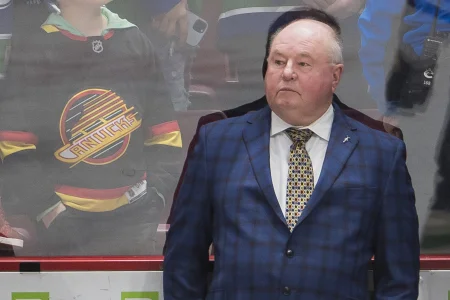 Dec 3, 2022; Vancouver, British Columbia, CAN; Vancouver Canucks head coach Bruce Boudreau watches from the bench during warm up prior to a game against the Arizona Coyotes at Rogers Arena.