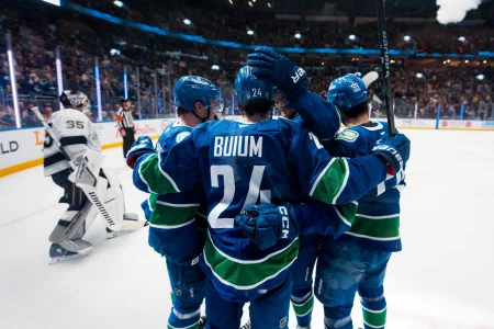 Apr 14, 2026; Vancouver, British Columbia, CAN; Vancouver Canucks defenseman Zeev Buium (24) and forward Nils Hoglander (21) and forward Elias Pettersson (40) and defenseman Kirill Kudryavtsev (59) celebrate Buiums goal against the Los Angeles Kings in the second period at Rogers Arena.