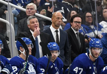 Oct 8, 2022; Toronto, Ontario, CAN; Toronto Maple Leafs head coach Sheldon Keefe (left) looks up at the scoreboard as assistant coaches Manny Malhotra (center) and Dean Chynoweth look on during a break in play against the Detroit Red Wings at Scotiabank Arena.