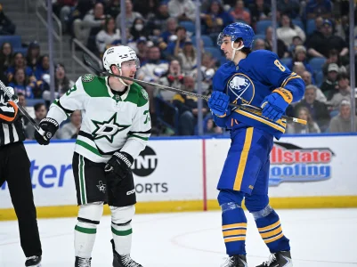 Apr 15, 2026; Buffalo, New York, USA; Buffalo Sabres defenseman Michael Kesselring (8) gives a high stick to the fsce of Dallas Stars left wing Adam Erne (73) in the third period at KeyBank Center.