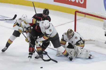 Jun 2, 2026; Raleigh, North Carolina, USA; Vegas Golden Knights defenseman Brayden McNabb (3) and defenseman Shea Theodore (27) and goaltender Carter Hart (79) defend against Carolina Hurricanes center Jordan Staal (11) during the third period in game one of the 2026 Stanley Cup Final at Lenovo Center.