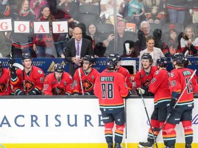 Head coach Dan Bylsma, standing back row center, and assistant Jessica Campbell, standing back right, coach the Coachella Valley Firebirds against the San Diego Gulls at Acrisure Arena in Palm Desert, Calif, April 21, 2024.
