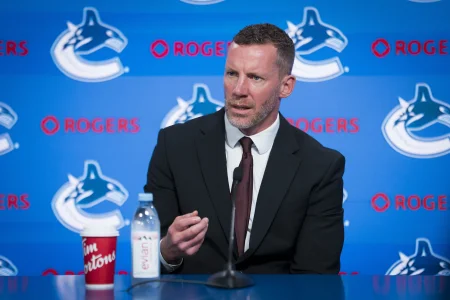 Jun 4, 2026; Vancouver, BC, CANADA; General manager Ryan Johnson speaks in a press conference where the Vancouver Canucks introduce Manny Malhotra as their new head coach at Rogers Arena.
