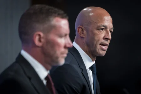Jun 4, 2026; Vancouver, BC, CANADA; General manager Ryan Johnson listens to Manny Malhotra speak during press conference where the Vancouver Canucks introduce Malhotra as their new head coach during a press conference at Rogers Arena.