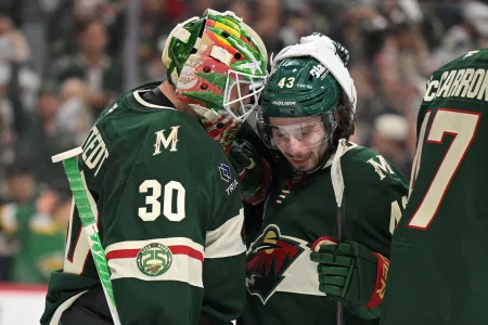 Apr 30, 2026; Saint Paul, Minnesota, USA; Minnesota Wild goalie Jesper Wallstedt (30) and defensemen Quinn Hughes (43) celebrate a series win against the Dallas Stars after game six of the first round of the 2026 Stanley Cup Playoffs at Grand Casino Arena
