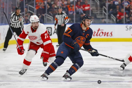 Feb 15, 2023; Edmonton, Alberta, CAN; Edmonton Oilers forward Connor McDavid (97) and Detroit Red Wings forward Dylan Larkin (71) look for a loose puck during the second period at Rogers Place.