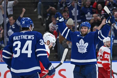 Oct 13, 2025; Toronto, Ontario, CAN; Toronto Maple Leafs right wing Calle Jarnkrok (19) celebrates a goal with center Auston Matthews (34) in the third period at Scotiabank Arena.