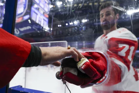 Apr 13, 2026; Tampa, Florida, USA; Detroit Red Wings center Dylan Larkin (71) gives a puck to a fan before a game against the Tampa Bay Lightning at Benchmark International Arena.