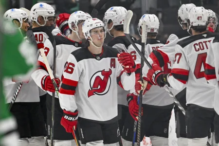 Mar 24, 2026; Dallas, Texas, USA; New Jersey Devils center Jack Hughes (86) celebrates the win over the Dallas Stars with his teammates at the American Airlines Center.