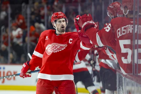 Jan 7, 2025; Detroit, Michigan, USA; Detroit Red Wings center Dylan Larkin (71) receives congratulations from teammates after scoring in the first period against the Ottawa Senators at Little Caesars Arena.