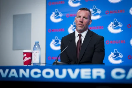 Jun 4, 2026; Vancouver, BC, CANADA; General manager Ryan Johnson speaks in a press conference where the Vancouver Canucks introduce Manny Malhotra as their new head coach at Rogers Arena.