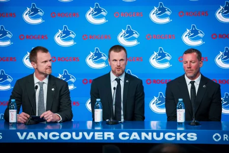 May 14, 2026; Vancouver, BC, Canada; Henrik Sedin and Ryan Johnson listen Daniel Sedin speak during a press conference where the Vancouver Canucks name new senior management staff. Henrik Sedin and his twin brother Daniel Sedin have been appointed as co-presidents of hockey operations and Ryan Johnson is now the new general manager of the club at Rogers Arena. May 14, 2026; Vancouver, BC, Canada; Henrik Sedin and Ryan Johnson listen Daniel Sedin speak during a press conference where the Vancouver Canucks name new senior management staff. Henrik Sedin and his twin brother Daniel Sedin have been appointed as co-presidents of hockey operations and Ryan Johnson is now the new general manager of the club at Rogers Arena.