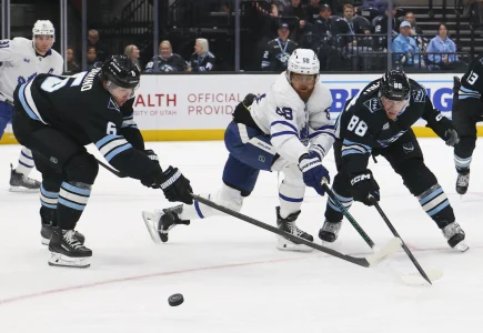 Jan 13, 2026; Salt Lake City, Utah, USA; Toronto Maple Leafs right wing William Nylander (88) battles for the puck with Utah Mammoth defenseman John Marino (6) and defenseman Nate Schmidt (88) during the first period at Delta Center.
