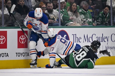 Mar 12, 2026; Dallas, Texas, USA; Edmonton Oilers center Connor McDavid (97) collides with center Ryan Nugent-Hopkins (93) and Dallas Stars center Sam Steel (18) during the first period at the American Airlines Center.