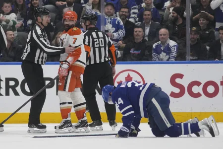 Mar 12, 2026; Toronto, Ontario, CAN; Anaheim Ducks defenseman Radko Gudas (7) looks at an injured Toronto Maple Leafs forward Auston Matthews (34) after he delivered a knee on knee hit during the second period at Scotiabank Arena.