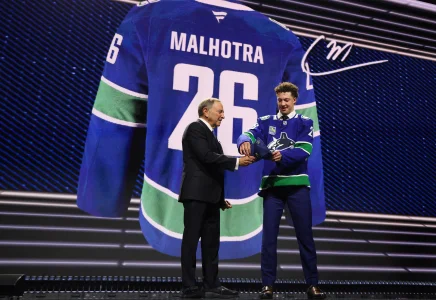 Jun 26, 2026; Buffalo, New York, USA; Caleb Malhotra reacts with NHL commissioner Gary Bettman after being selected with the third pick in the first round of the 2026 NHL Draft by the Vancouver Canucks at KeyBank Center.