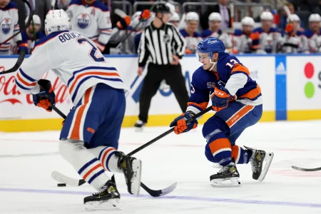 Nov 23, 2022; Elmont, New York, USA; New York Islanders center Mathew Barzal (13) controls the puck against Edmonton Oilers defenseman Evan Bouchard (2) during the second period at UBS Arena.