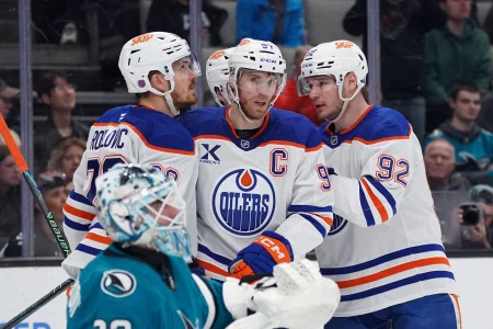 Apr 8, 2026; San Jose, California, USA; Edmonton Oilers center Connor McDavid (97) is congratulated by teammates after scoring against the San Jose Sharks during the first period at SAP Center at San Jose.