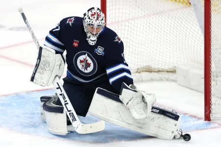 Mar 24, 2026; Winnipeg, Manitoba, CAN; Winnipeg Jets goaltender Connor Hellebuyck (37) makes a skate save against the Vegas Golden Knights in the third period at Canada Life Centre.