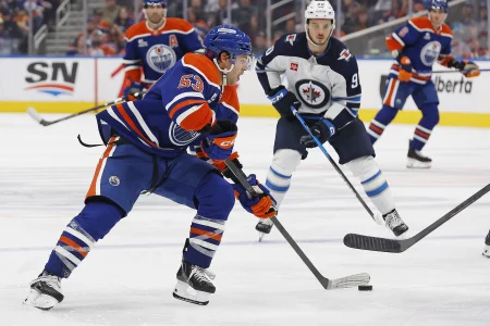 Sep 19, 2026; Edmonton, Alberta, CAN; Edmonton Oilersforward Issac Howard (53) looks to make a pass in front of Winnipeg Jets forward Nikita Chibrikov (90) during the third period at Rogers Place. Mandatory Credit: Perry Nelson-Imagn Images