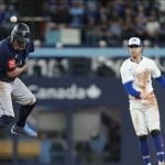 Oct 20, 2025; Toronto, Ontario, CAN; Seattle Mariners first baseman Josh Naylor (12) interferes with a throw to first resulting in a double play in the first inning against the Toronto Blue Jays during game seven of the ALCS round for the 2025 MLB playoffs at Rogers Centre. Mandatory Credit: Nick Turchiaro-Imagn Images