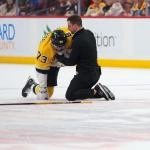 Feb 4, 2026; Sunrise, Florida, USA; Boston Bruins defenseman Charlie McAvoy (73) is looked at by a trainer after an apparent injury against the Florida Panthers during the first period at Amerant Bank Arena.