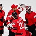 Feb 13, 2026; Milan, Italy; Nathan MacKinnon, Sidney Crosby, Darcy Kuemper and Logan Thompson of Canada celebrate after the match against Switzerland in men\'s ice hockey group A play during the Milano Cortina 2026 Olympic Winter Games at Milano Santagiulia Ice Hockey Arena.