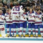 Feb 22, 2026; Milan, Italy; United States players celebrate with their gold medals and the jersey of Johnny Gaudreau after defeating Canada in the men\'s ice hockey gold medal game during the Milano Cortina 2026 Olympic Winter Games at Milano Santagiulia Ice Hockey Arena.