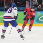 Feb 22, 2026; Milan, Italy; Macklin Celebrini (17) of Canada in action against Quinn Hughes (43) of the United States in the men\'s ice hockey gold medal game during the Milano Cortina 2026 Olympic Winter Games at Milano Santagiulia Ice Hockey Arena.