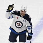 Jan 19, 2026; Chicago, Illinois, USA; Winnipeg Jets center Jonathan Toews (19) acknowledges the crowd during the first period of his first game back at the United Center since leaving the Chicago Blackhawks at United Center.