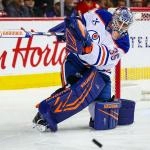 Feb 4, 2026; Calgary, Alberta, CAN; Edmonton Oilers goaltender Tristan Jarry (35) shoots the puck against the Calgary Flames during the second period at Scotiabank Saddledome. Mandatory Credit: Sergei Belski-Imagn Images