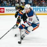 Jan 17, 2026; Vancouver, British Columbia, CAN; Vancouver Canucks defenseman Victor Mancini (90) stick checks Edmonton Oilers forward Andrew Mangiapane (88) in the third period at Rogers Arena.