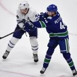 Dec 10, 2019; Vancouver, British Columbia, CAN; Toronto Maple Leafs defenseman Morgan Rielly (44) defends against Vancouver Canucks forward Elias Pettersson (40) during the third period at Rogers Arena