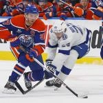 Mar 21, 2026; Edmonton, Alberta, CAN; Edmonton Oilers forward Connor McDavid (97) carries the puck past Tampa Bay Lightning forward Pontus Holmberg (29) during the third period at Rogers Place. Mandatory Credit: Perry Nelson-Imagn Images