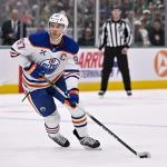 Mar 21, 2026; Edmonton, Alberta, CAN; Edmonton Oilers forward Connor McDavid (97) carries the puck past Tampa Bay Lightning forward Pontus Holmberg (29) during the third period at Rogers Place.