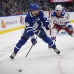 Mar 25, 2026; Toronto, Ontario, CAN; Toronto Maple Leafs forward William Nylander (88) goes to pass the puck as New York Rangers defenseman Braden Schneider (4) closes in during the third period at Scotiabank Arena.